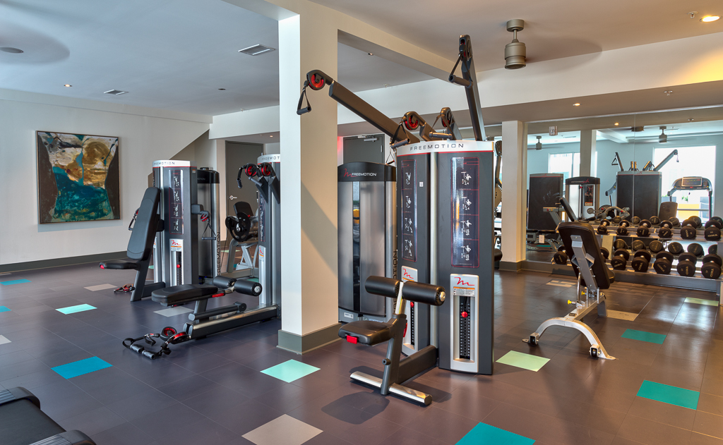 Indoor gym area with workout machines and lifting weights