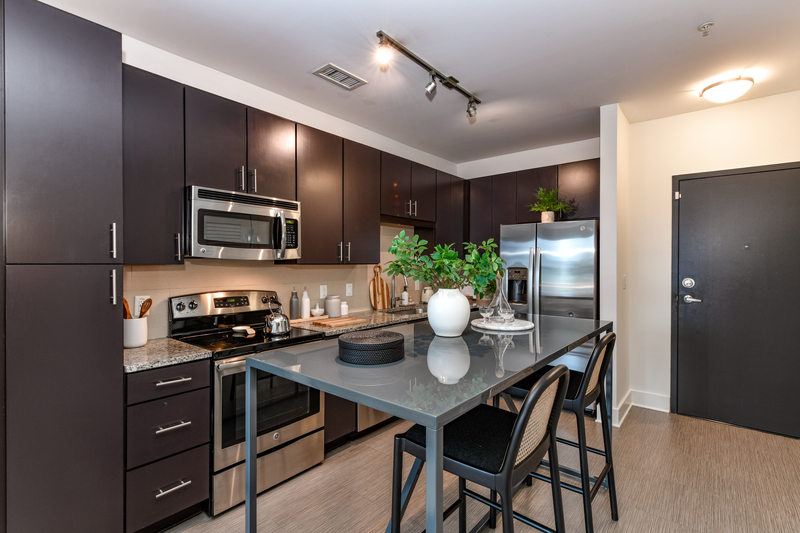 Kitchen with granite counters, stainless steel appliances, and island seating